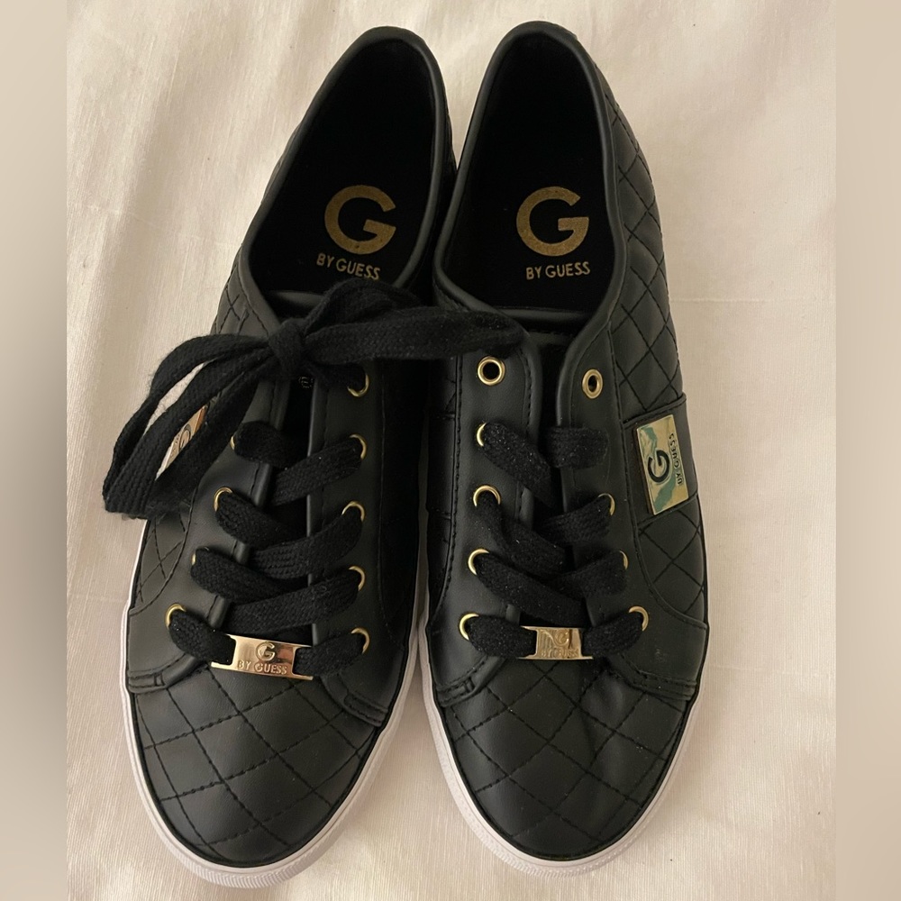 Guess black quilted sneakers. Gold logos and detailing.